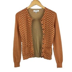 Isaac Mizrahi tan and orange cardigan
